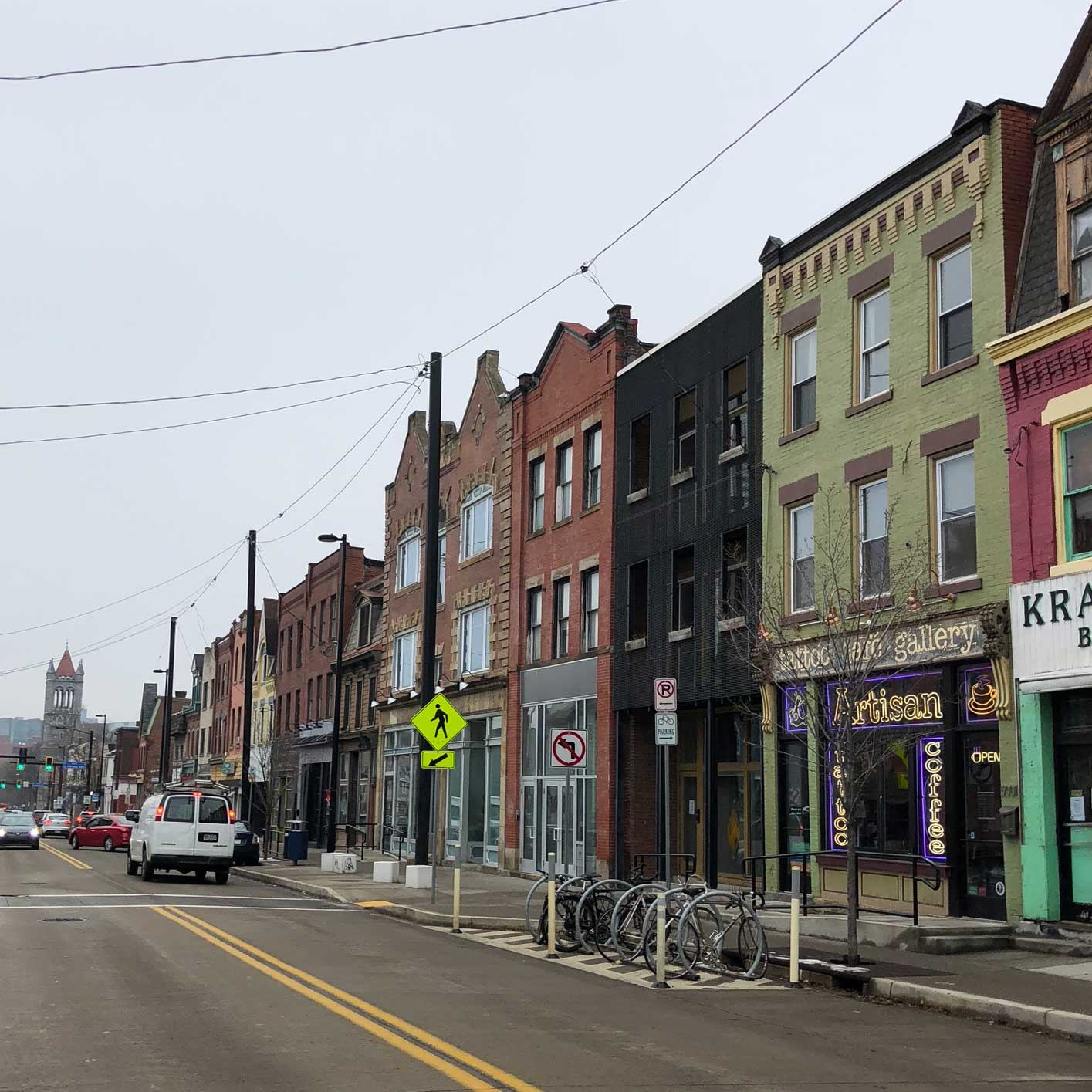 An image of a grey sky and quaint buildings on Penn Ave. in Pittsurgh