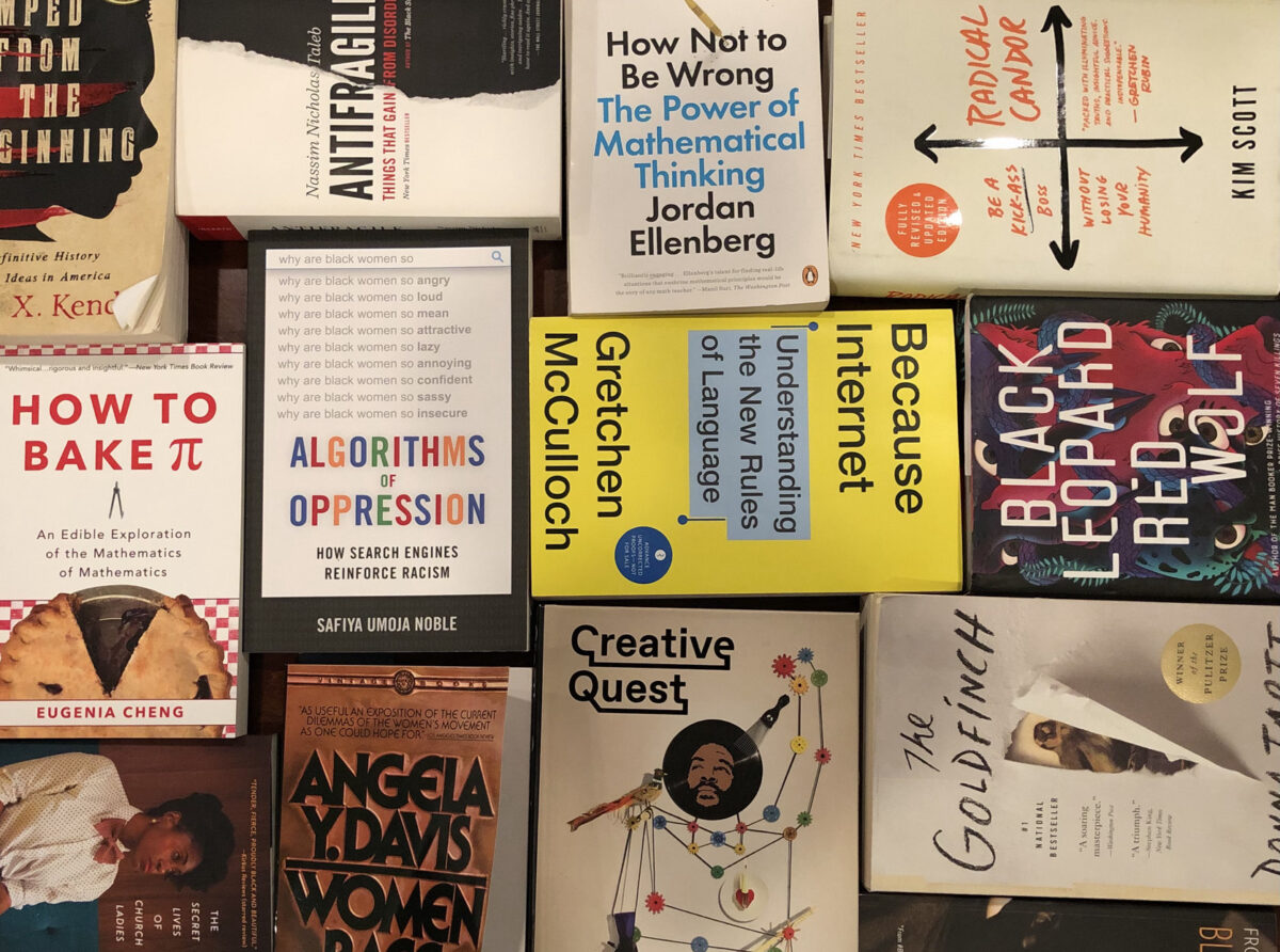 A selection of books aligned in a grid on a table