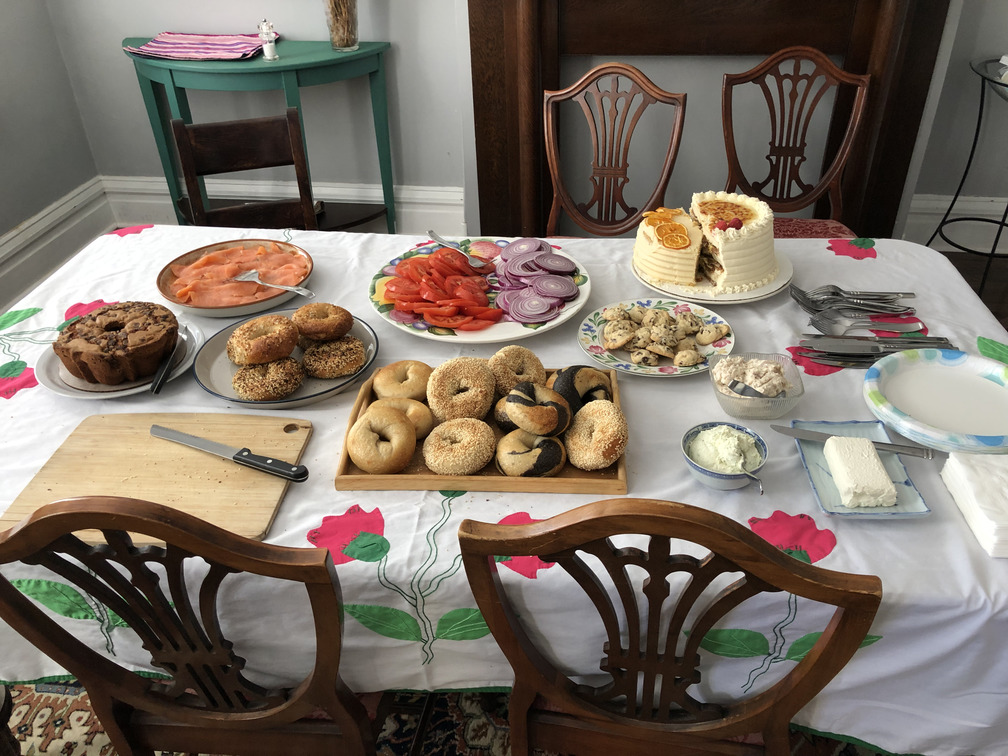 A table with bagels and other dishes set up for brunch